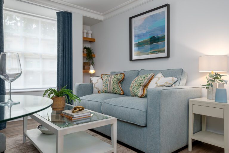 blue sofa with print behind it