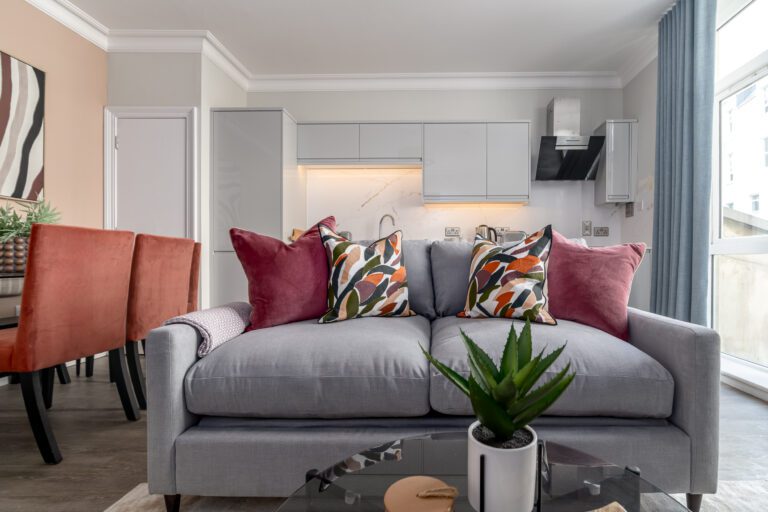 Close up of grey sofa with burgundy pillows