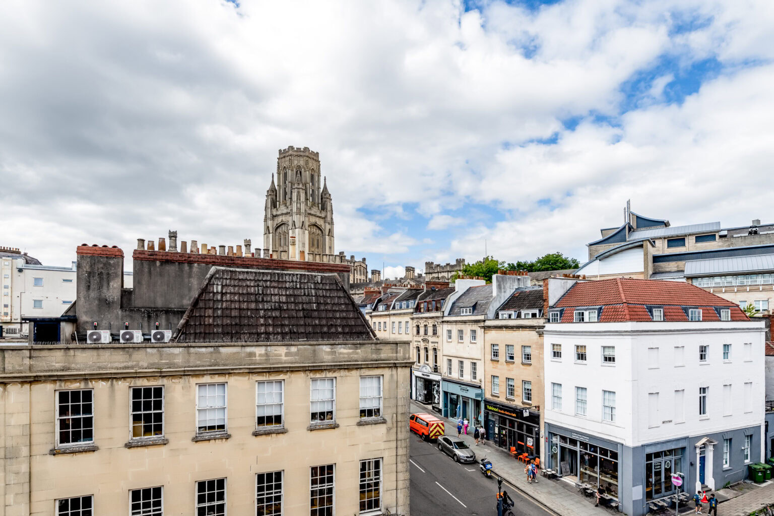 A view of a city street with buildings and a clock tower.