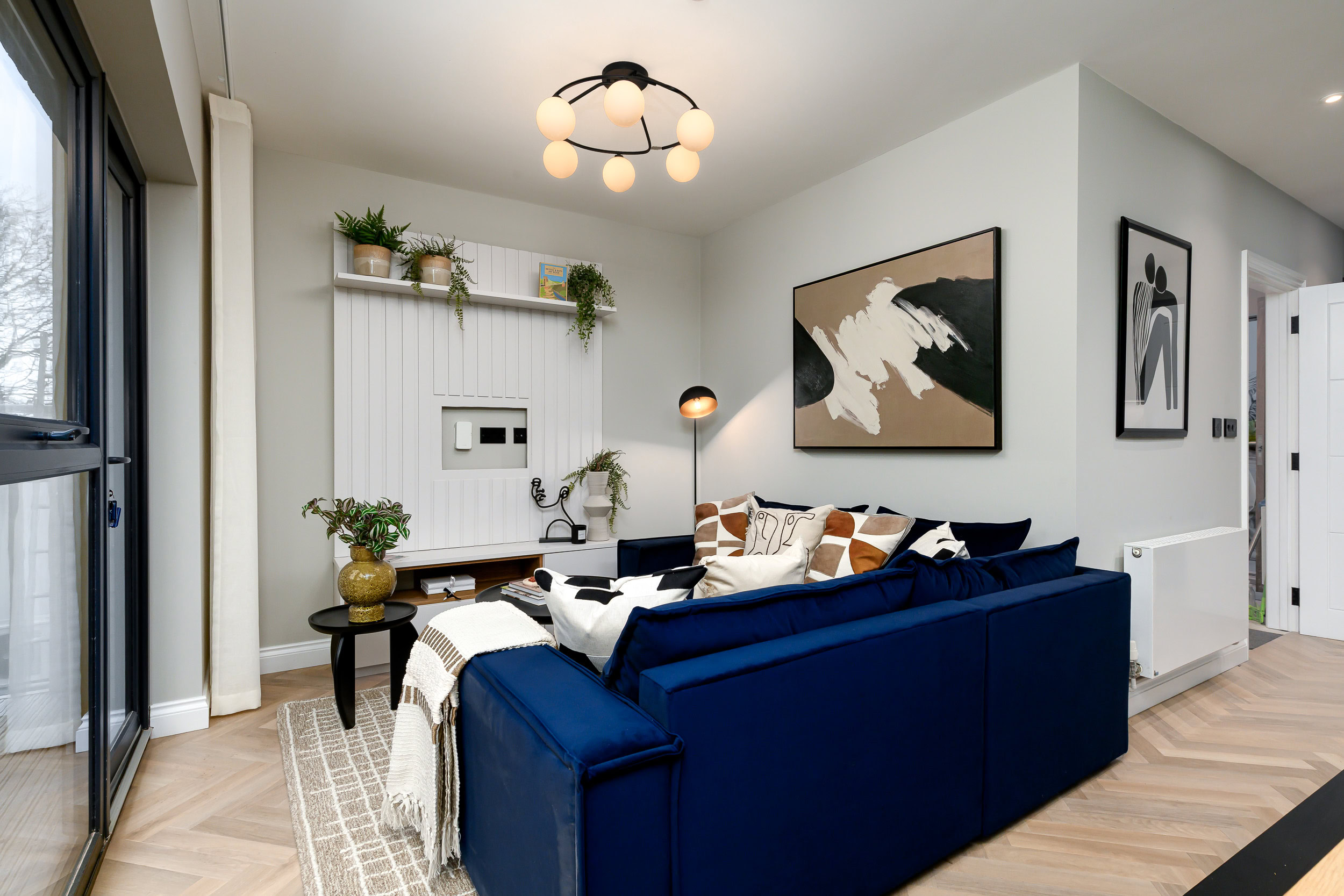 A living room featuring a blue couch and a matching blue chair, creating a cohesive and inviting seating area.
