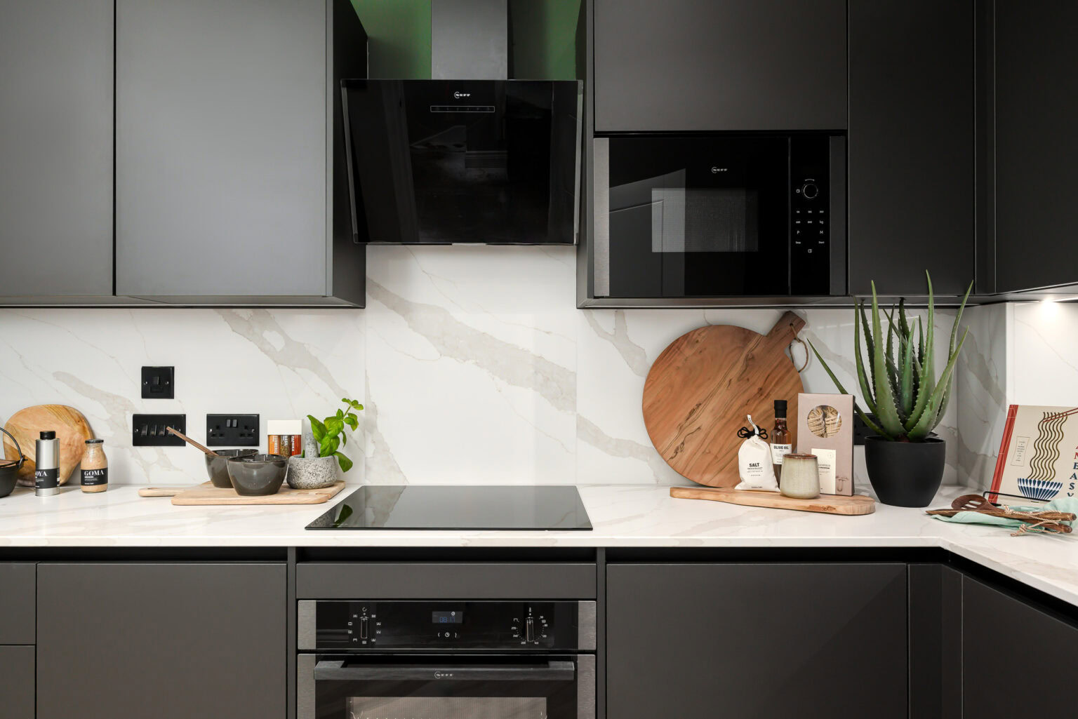A well-equipped kitchen showcasing a stove and oven, surrounded by cabinets and a clean countertop.