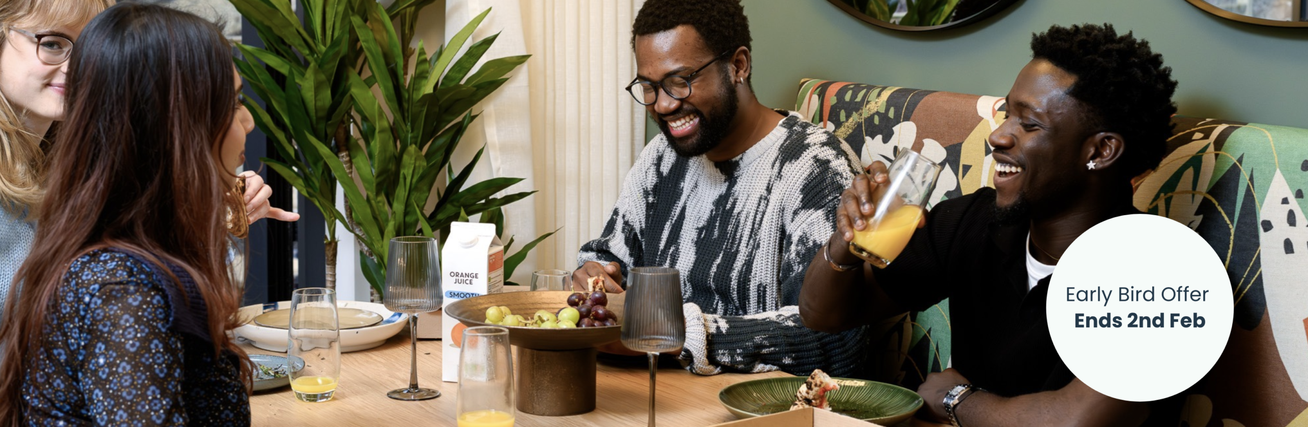 Group of people laughing at a dining table