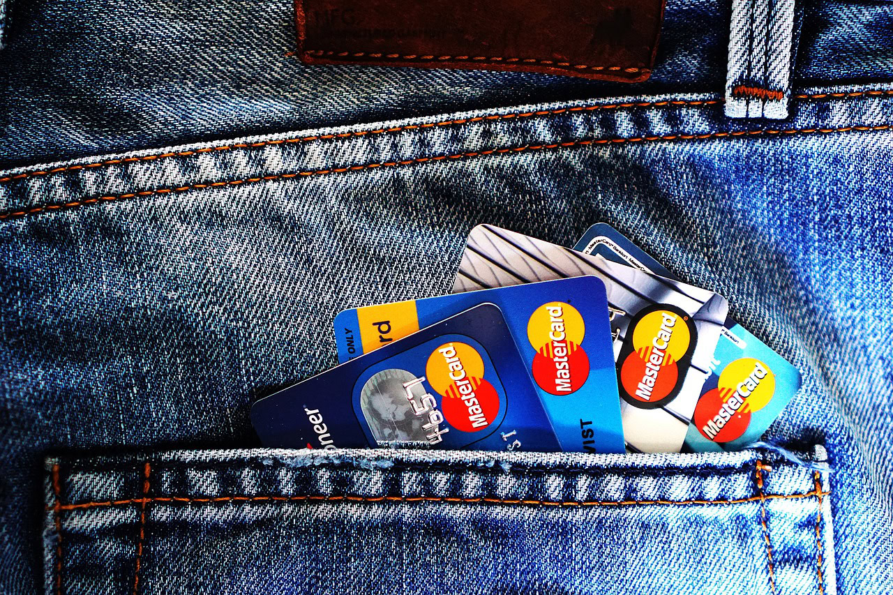 Bank cards tucked into a denim pocket, the reward for a completed account application.