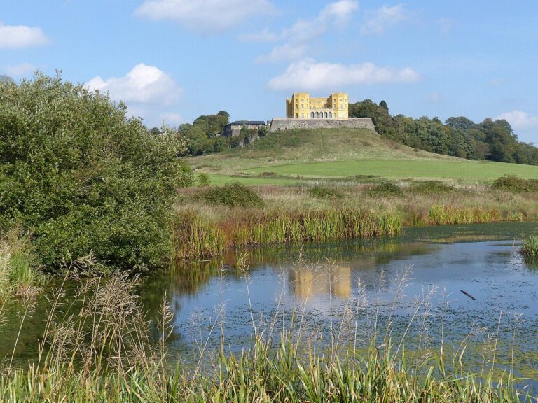 The yellow Dower House on the hill above Duchess Pond in Stoke Park