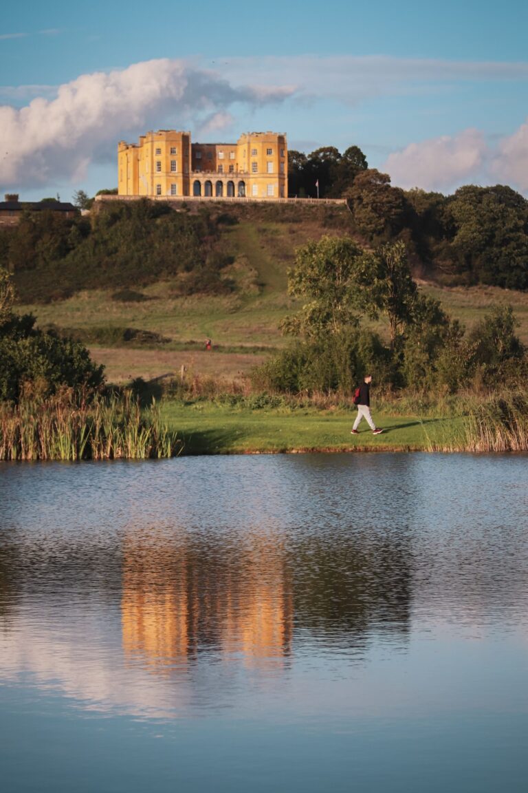 The Dower House reflected in a lake in Stoke Park