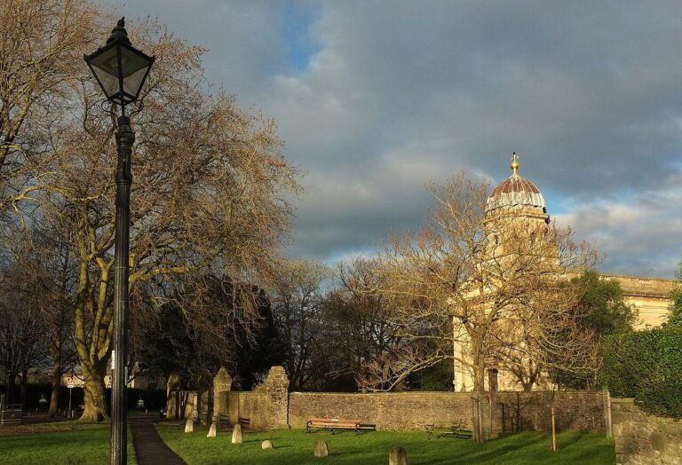 Redland Chapel in warm evening light beside an old lamppost