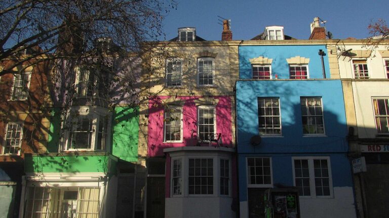 Green, pink and blue painted terrace houses on Stokes Croft